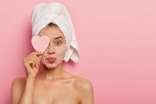 reducing pores cleansing concept attractive female applies sea salt mask face has luxurious feelings from beauty treatments covers eye with heart shaped sponge pampers complexion